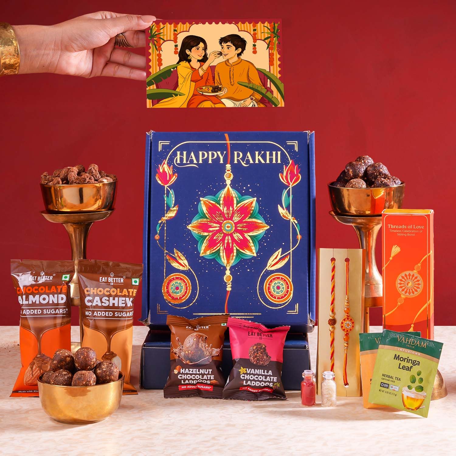 Eat Better Co Bandhan Rakhi Gift Hamper for Brother, 10-Item Snack Gift Set with 2 Rakhis, Chocolate Coated Cashews, Almonds