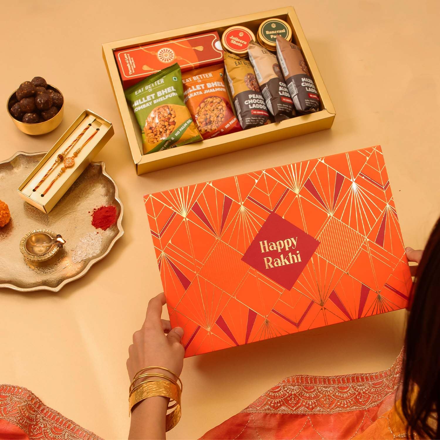 Eat Better Co Sneh Rakhi Gift Hamper for Brother, 11 Items, 2 Rakhis, Chocolate Laddoos, Millet Bhel, Roli-Chawal, Mukhwas -
