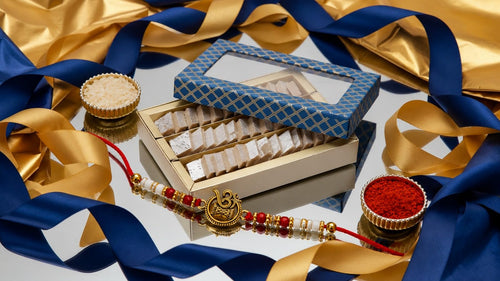 Ghasitaram Gifts Jaiccha Rakhi Gifts for Brothers Rakhi Sweets Mini Kaju Katli Blue Box with Om Rakhi