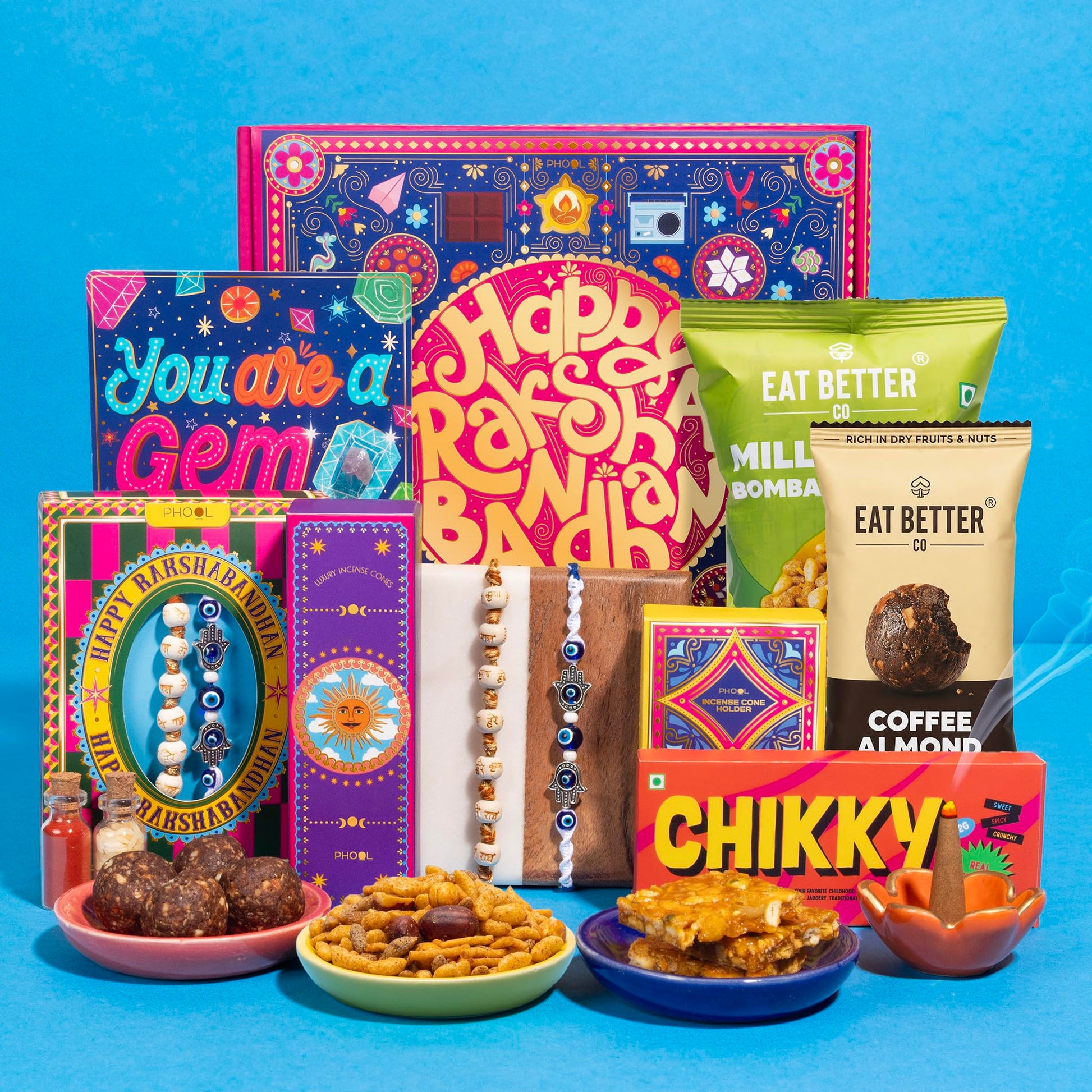 Phool Bandhan Rakhi Gift Hamper for Brother | 10-Item Rakhi Gift Set with 2 Rakhis, Incense, Laddoo & Chikki | Rakhi Gift Box