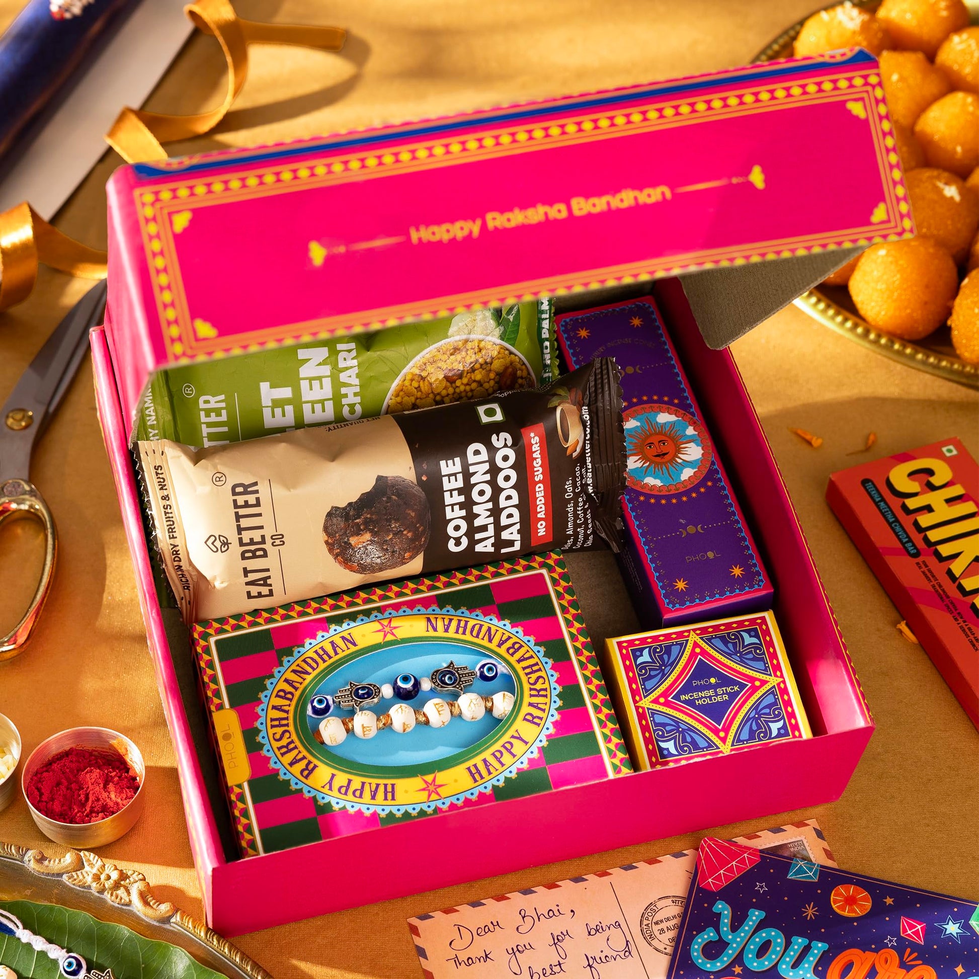 Phool Bandhan Rakhi Gift Hamper for Brother | 10-Item Rakhi Gift Set with 2 Rakhis, Incense, Laddoo & Chikki | Rakhi Gift Box