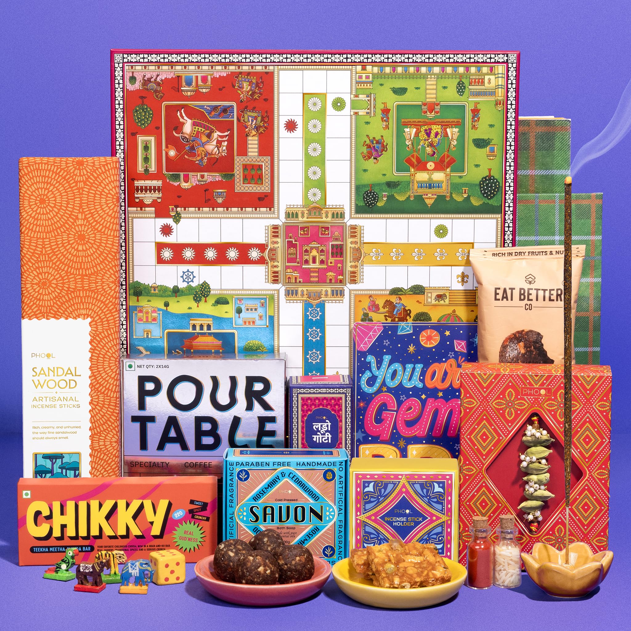 Phool Ludo Rakhi Gift Hamper for Brother | 13-Item Rakhi Gift Box with Elaichi Rakhi, Coffee, Laddoo, Chikki, Soap & Ludo Gam