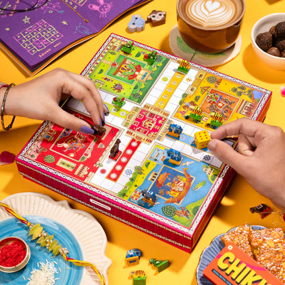Phool Ludo Rakhi Gift Hamper for Brother | 13-Item Rakhi Gift Box with Elaichi Rakhi, Coffee, Laddoo, Chikki, Soap & Ludo Gam