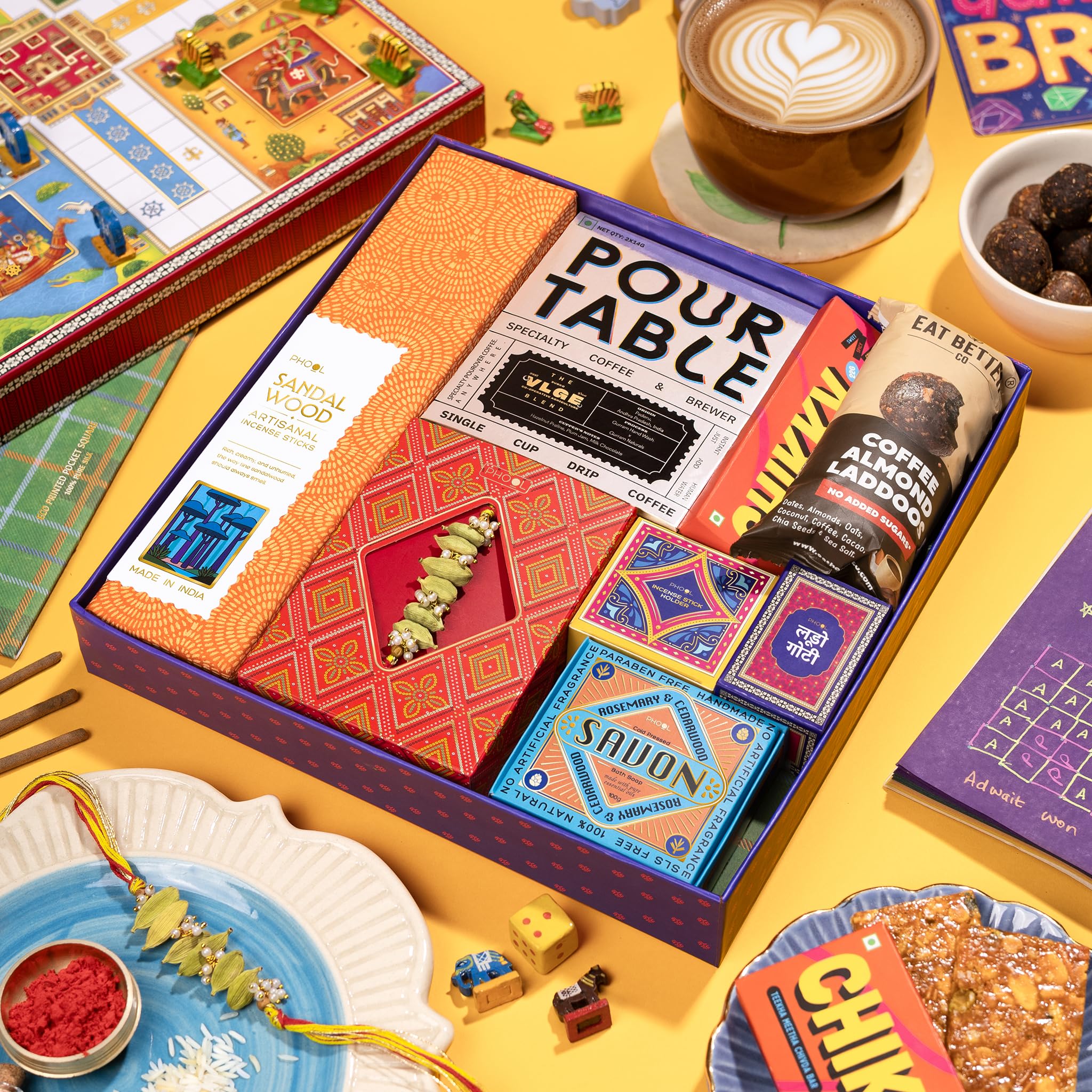 Phool Ludo Rakhi Gift Hamper for Brother | 13-Item Rakhi Gift Box with Elaichi Rakhi, Coffee, Laddoo, Chikki, Soap & Ludo Gam