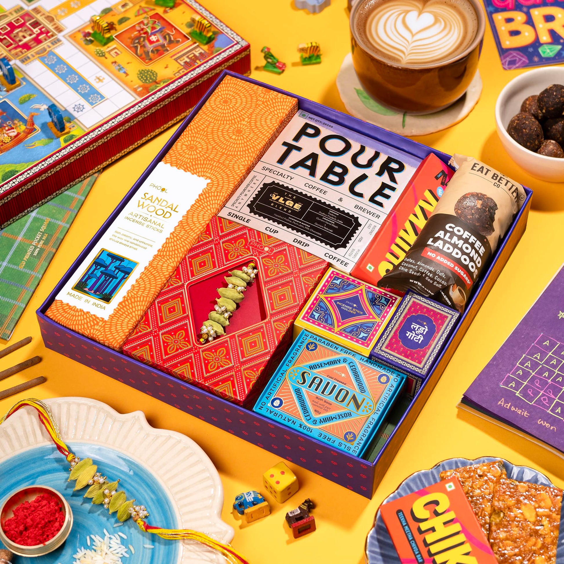 Phool Ludo Rakhi Gift Hamper for Brother | 13-Item Rakhi Gift Box with Elaichi Rakhi, Coffee, Laddoo, Chikki, Soap & Ludo Gam