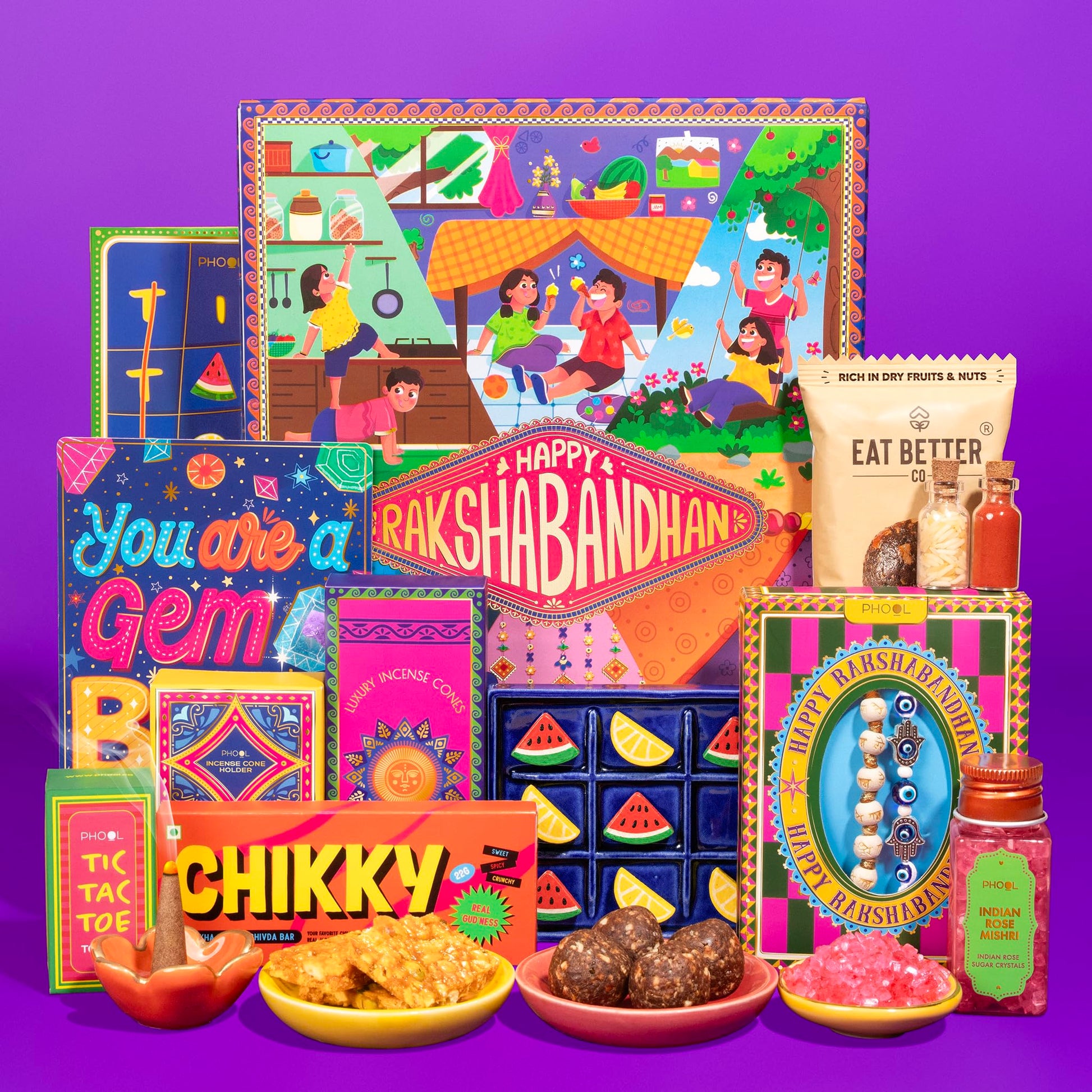 Phool Nostalgia Rakhi Gift Hamper for Brother | 11-Item Rakhi Gift Box with 2 Rakhis, Tic Tac Toe, Incense, Laddoo & Chikki |