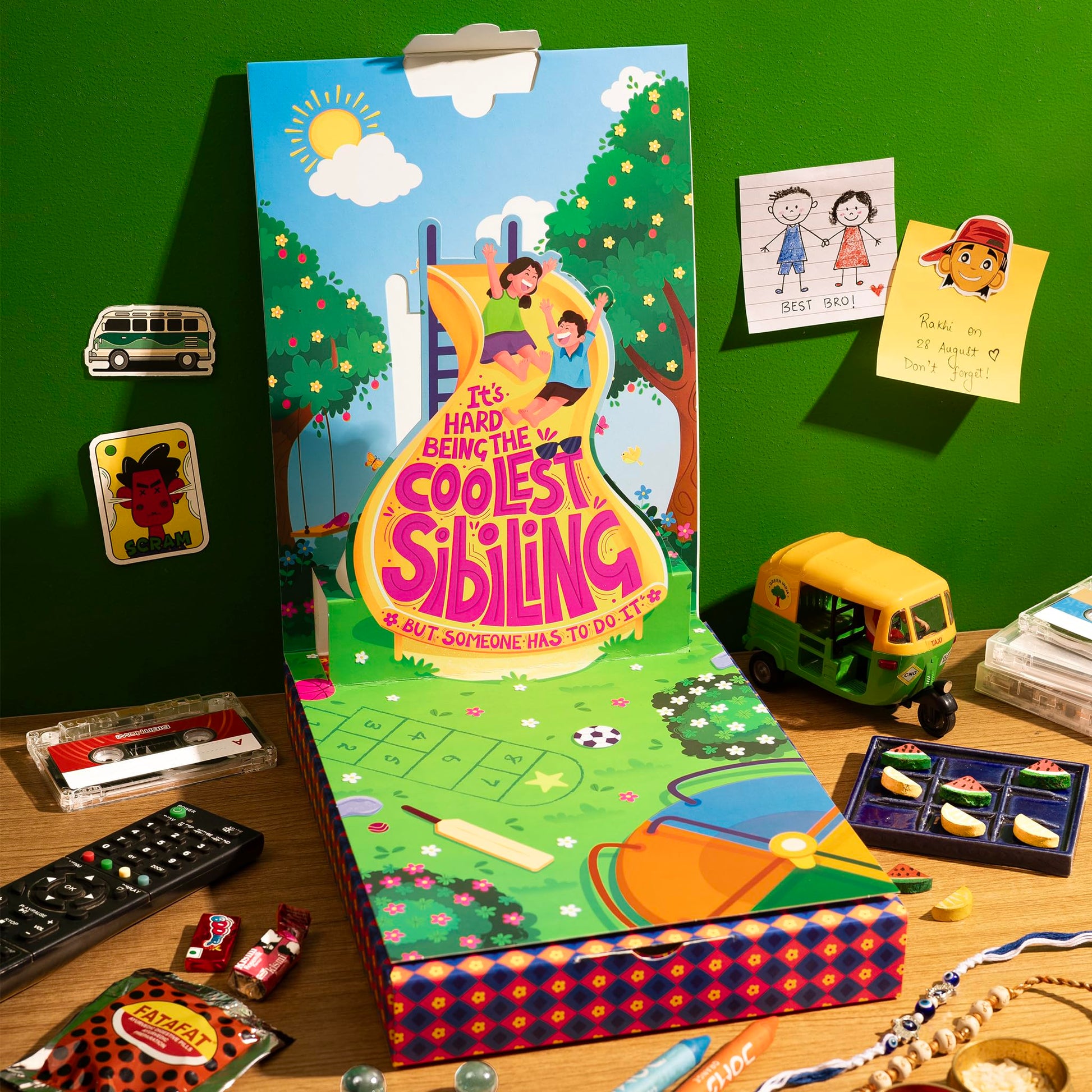 Phool Nostalgia Rakhi Gift Hamper for Brother | 11-Item Rakhi Gift Box with 2 Rakhis, Tic Tac Toe, Incense, Laddoo & Chikki |