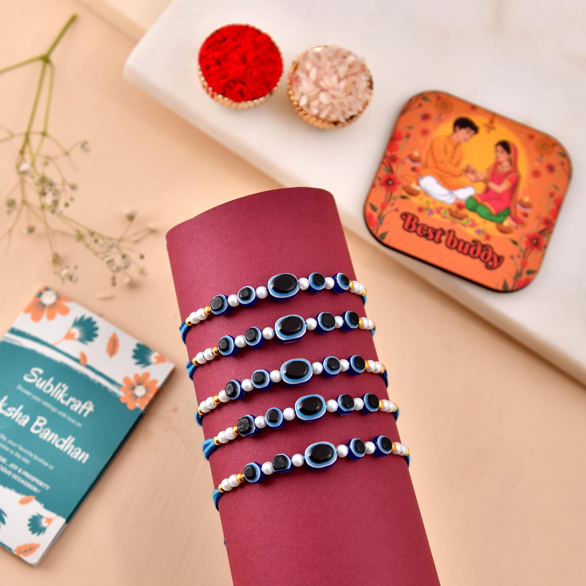 RENOVELIX Rakhi for Brother Set of 12 Evil Eye with Roli Chawal, 1 Printed Fridge Magnet & Greeting Card Combo Pack | Rakshab