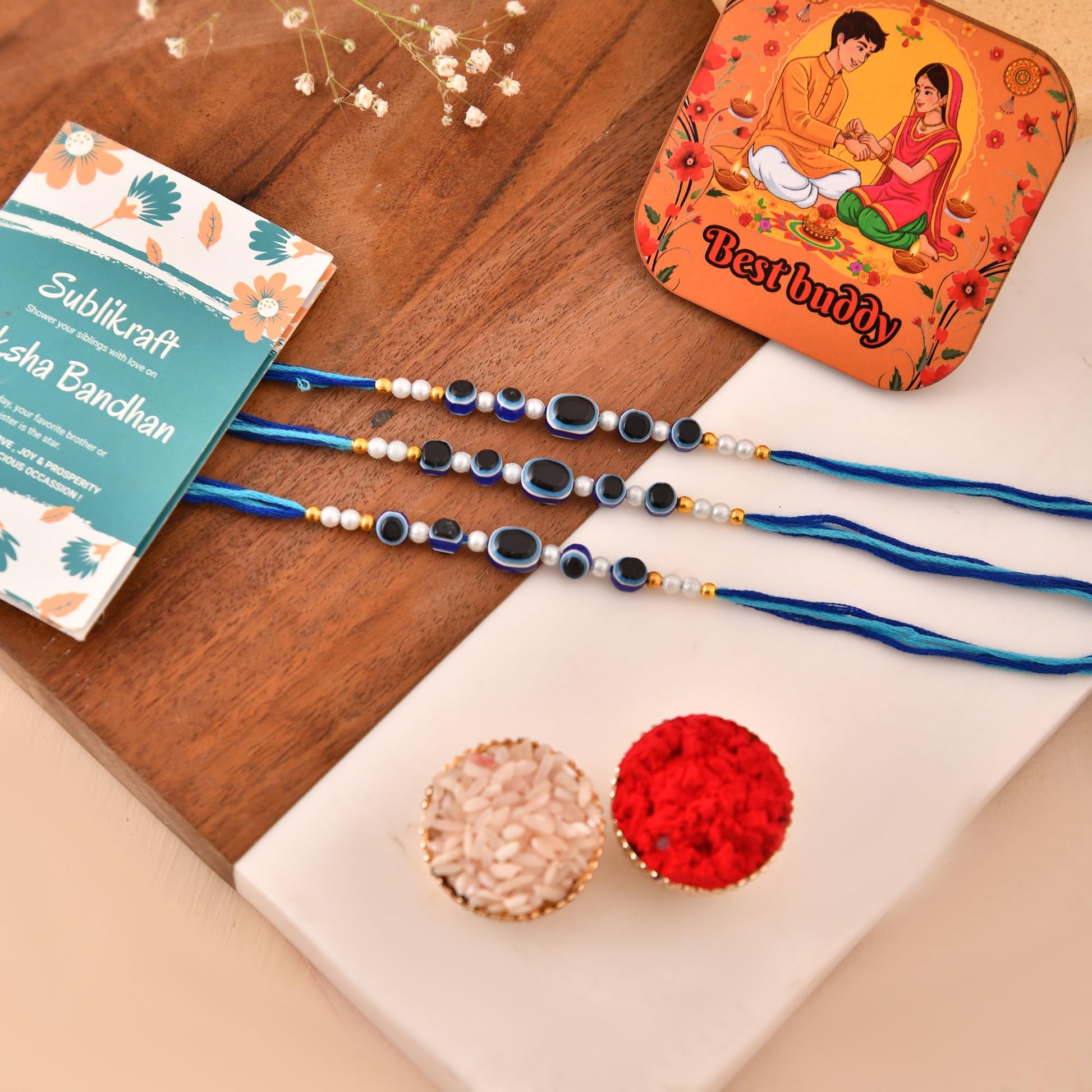 RENOVELIX Rakhi for Brother Set of 12 Evil Eye with Roli Chawal, 1 Printed Fridge Magnet & Greeting Card Combo Pack | Rakshab